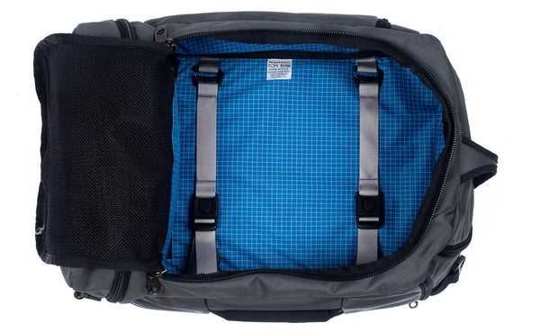An open Techonaut 30 with a Nebulous Grey (dark grey) exterior and an Island (blue) interior.